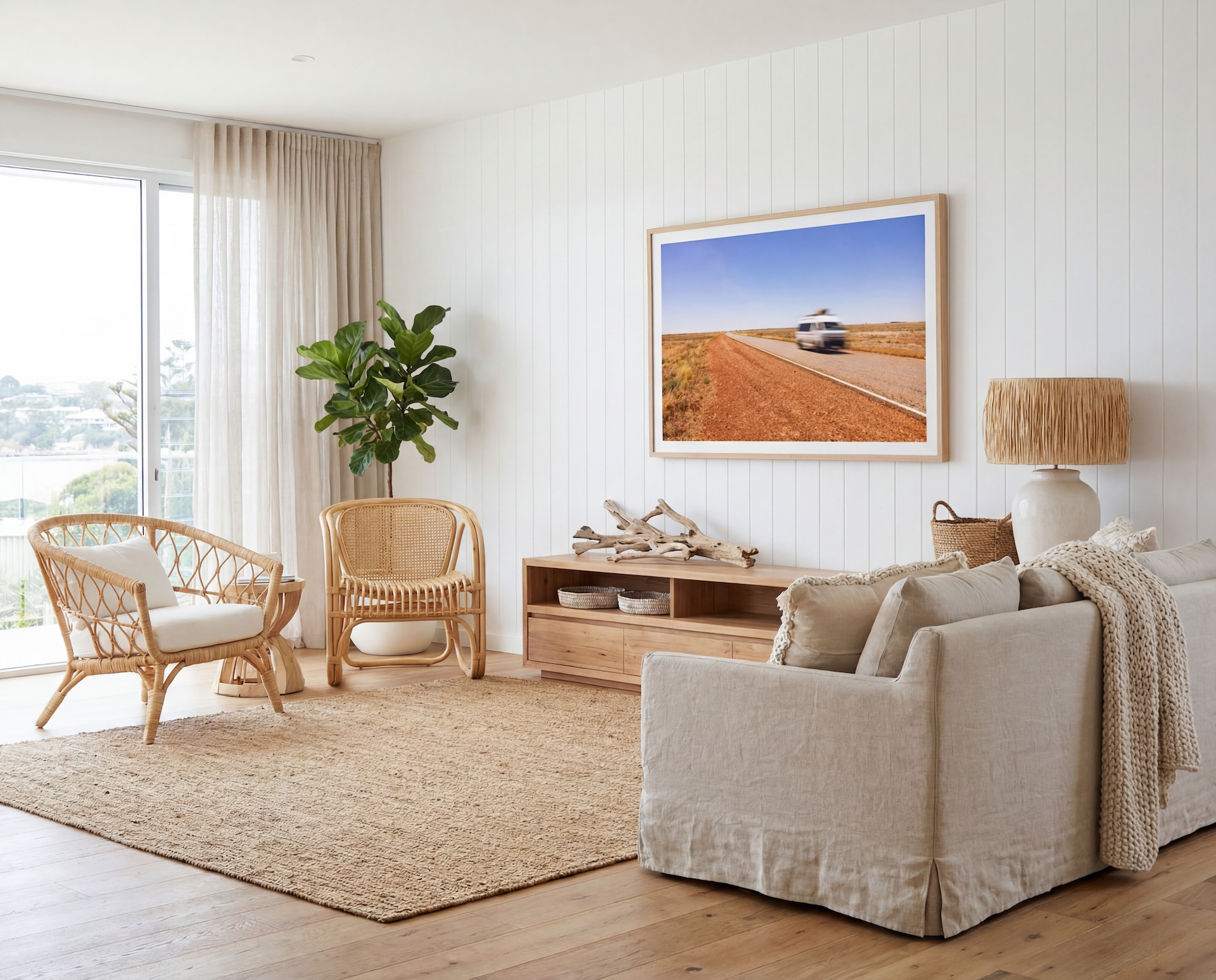 Living room with beige sofa, wicker chairs, and a framed picture on the wall. 2026 interior design trends recommended by interior stylists.